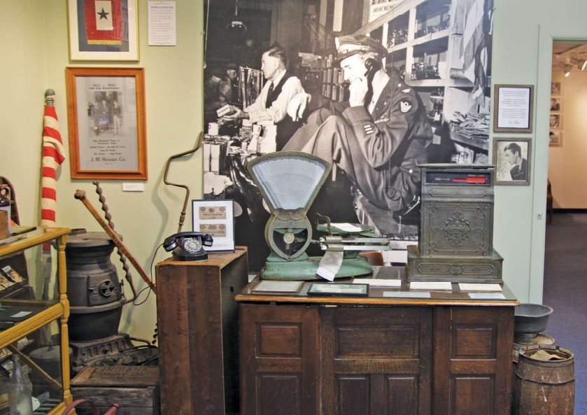 This display contains some of the original fixtures from the J.M. Stewart Hardware Store where Jimmy worked while growing up. The image on the wall shows him making calls from that store when he was home on leave from the U.S. Army Air Corps during WWII.