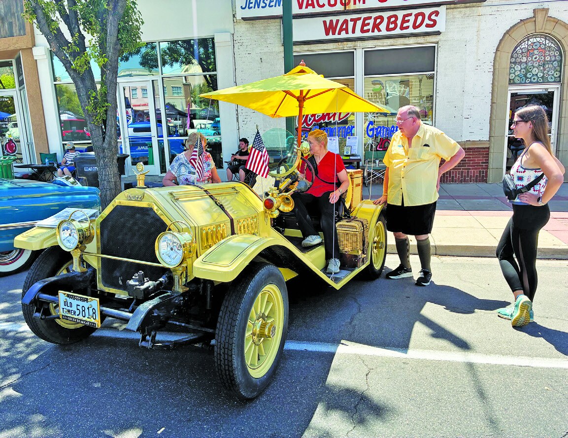 Tom Rowlett standing with his 1972 Bearcat-inspired vehicle